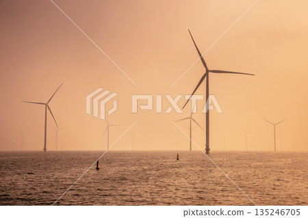 Offshore Wind farm at sea under cloudy sunset sky 135246705