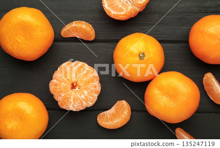 Tasty tangerines on black wooden background 135247119
