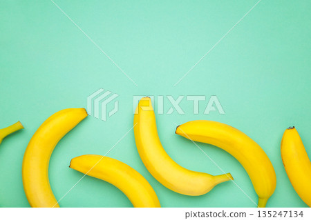 Yellow bananas flat lay on mint background. Space for text Yellow bananas flat lay on mint background. Space for text 135247134