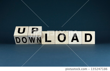 Wooden blocks arranged to spell UPLOAD and DOWNLOAD 135247186