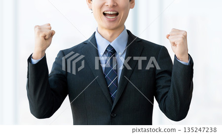 Male businessman doing guts pose Male businessman doing guts pose 135247238
