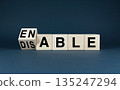 Wooden blocks spelling Enable or Disable 135247294