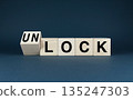 Wooden blocks spelling Lock or Unlock. 135247303
