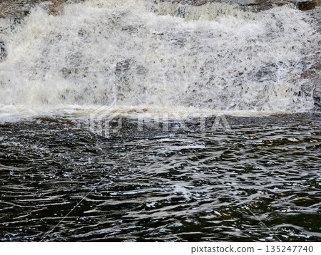 wild nature scene, majestic waterfall in nature, powerful waterfall cascading into tranquil pool 135247740