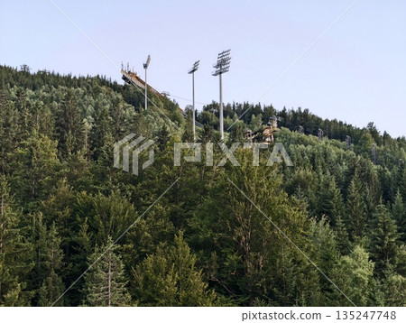 lights contrast nature, dramatic scene where stadium lighting intersects with rugged mountain lights contrast nature, dramatic scene where stadium lighting intersects with rugged mountain 135247748