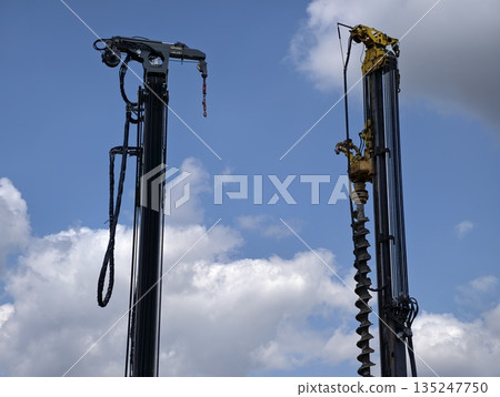 largescale earthworks with rugged drilling equipment and hydraulic hoses preparing foundation largescale earthworks with rugged drilling equipment and hydraulic hoses preparing foundation 135247750