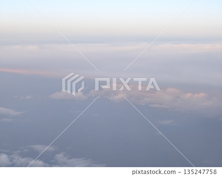 calm ocean with distant coastline, aerial scene showing serene ocean and scattered clouds 135247758