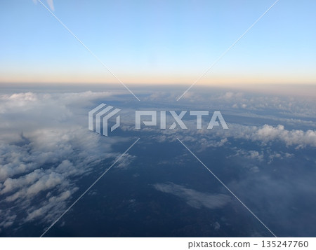 wing outline over evening coastal scene, aircraft silhouette against sunset over seashore at dusk wing outline over evening coastal scene, aircraft silhouette against sunset over seashore at dusk 135247760