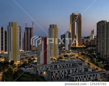 vibrant city skyline transforms into energetic nightlife hub with glowing buildings and active vibrant city skyline transforms into energetic nightlife hub with glowing buildings and active 135247783
