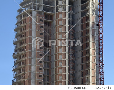 building in progress, ongoing building process with exposed structures and temporary platforms 135247815