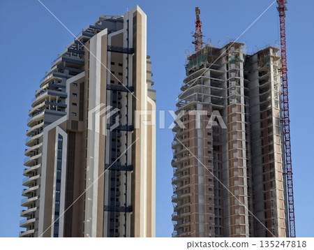 active construction of twin towers, overview of construction site with twin towers being built active construction of twin towers, overview of construction site with twin towers being built 135247818