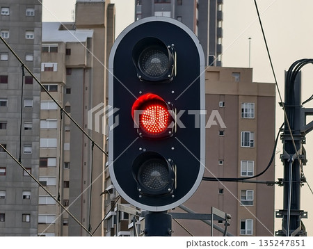 traffic light signifies city commuter pause, red signal indicates momentary halt for city drivers 135247851