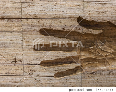 historic stone impression with measurements, closeup of carved hand impression with historical 135247853