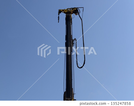 vertical industrial crane highlighting maintenance mood and structural details in daylight 135247858