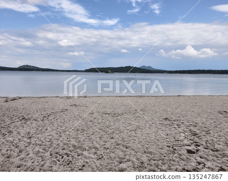 quiet beach with tranquil waters, silent shoreline reflecting peaceful waters beneath soft sky quiet beach with tranquil waters, silent shoreline reflecting peaceful waters beneath soft sky 135247867