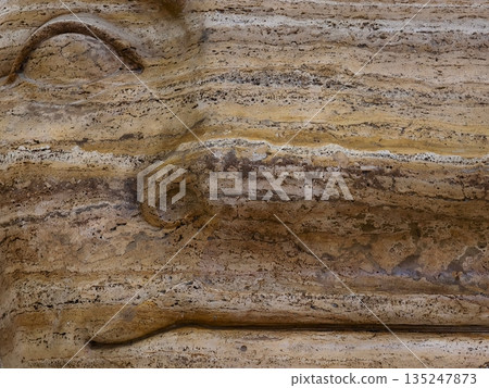horizontal bedding and color variation, closeup of sedimentary sandstone with grain measurement 135247873