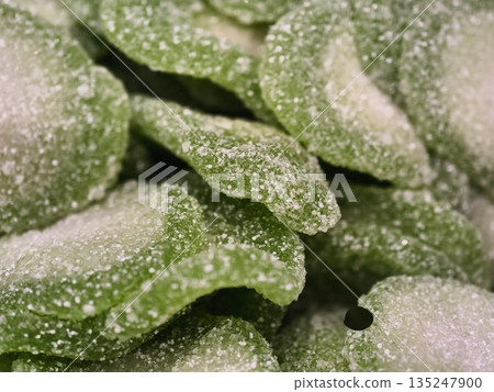 stylized studio display of tart lime and apple flavored plantshaped sweets coated with sugar 135247900