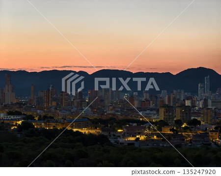 Evening view panorama, Nightfall illuminates seaside urban Evening view panorama, Nightfall illuminates seaside urban 135247920