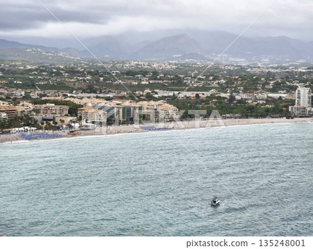 Peaceful coastal scene, Calm waters with distant mountains Peaceful coastal scene, Calm waters with distant mountains 135248001