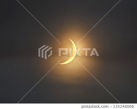 Nighttime celestial glow, Gentle amber halo illuminates misty Nighttime celestial glow, Gentle amber halo illuminates misty 135248008