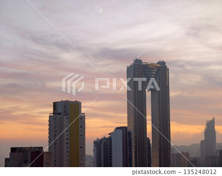Serene metropolis with radiant sunset and reflective glass Serene metropolis with radiant sunset and reflective glass 135248012