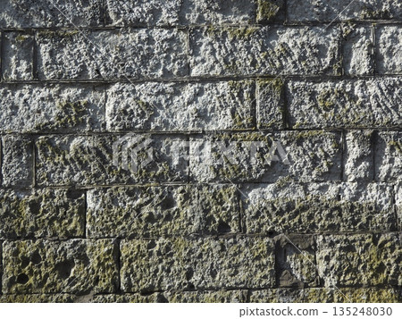 A tasteful stone wall that has been covered with moss over the years. The texture of the stone wall evokes the feeling of a traditional Japanese townscape. A tasteful stone wall that has been covered with moss over the years. The texture of the stone wall evokes the feeling of a traditional Japanese townscape. 135248030