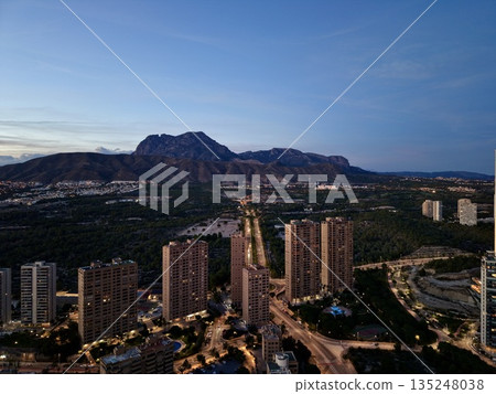 twilight aerial view of urban landscape, sunset city panorama with skyscrapers and illuminated streets twilight aerial view of urban landscape, sunset city panorama with skyscrapers and illuminated streets 135248038