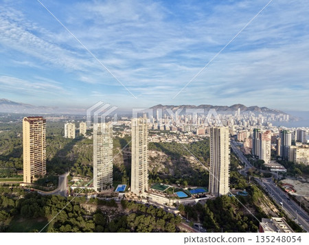 urban towers amid lush surroundings, highrise residences nestled within verdant park areas and trees urban towers amid lush surroundings, highrise residences nestled within verdant park areas and trees 135248054