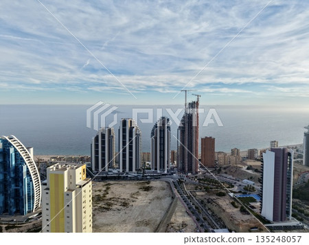elegant seaside buildings under development, luxury towers along peaceful shoreline being built elegant seaside buildings under development, luxury towers along peaceful shoreline being built 135248057