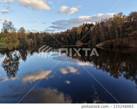 peaceful village by shimmering water, calm waters mirror colorful trees and peaceful village surroundings peaceful village by shimmering water, calm waters mirror colorful trees and peaceful village surroundings 135248065