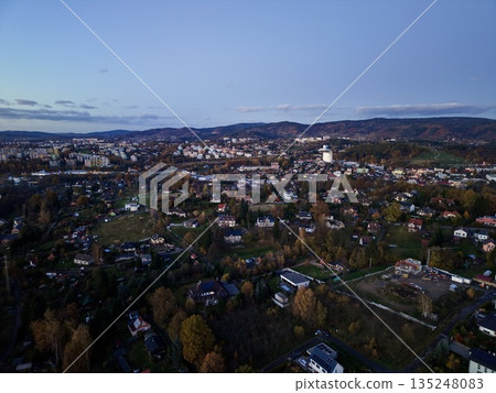 serene aerial perspective capturing church spire amidst softly illuminated townscape at dusk serene aerial perspective capturing church spire amidst softly illuminated townscape at dusk 135248083