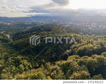 Gentle Sunset Illumination Over Peaceful Forested Hilltop Offering Relaxation And Serenity 135248222