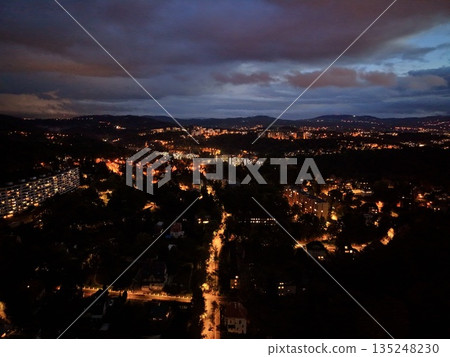 Nighttime Cityscape With Glowing Streets, Drone View Showcasing Illuminated Streets And Scenic City Backdrop 135248230