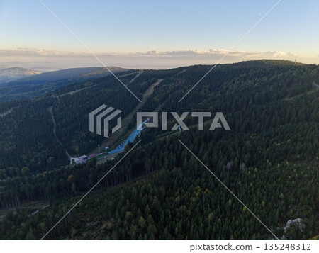 Empty Winter Landscape, Deserted Snowy Hillside With Trees, Quiet Snowcovered Slope Amidst Dense Trees Empty Winter Landscape, Deserted Snowy Hillside With Trees, Quiet Snowcovered Slope Amidst Dense Trees 135248312