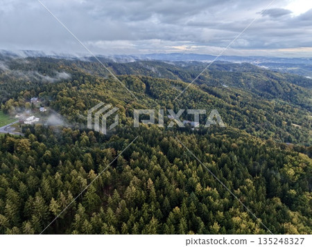Panoramic Aerial Scene Capturing Layered Terrain And Soft Cloud Formations In Moody Atmosphere 135248327