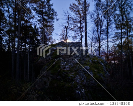 Dusk Under Trees, Soft Evening Lighting Highlights Rugged Granite And Darkened Silhouette Of Pine Trees Dusk Under Trees, Soft Evening Lighting Highlights Rugged Granite And Darkened Silhouette Of Pine Trees 135248368
