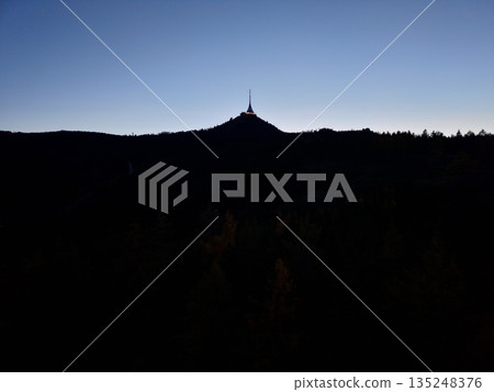 Twilight Mountain View, Silhouette Of Solitary Tower, Sunset Horizon With Shadowed Forests And Rugged Ridge Twilight Mountain View, Silhouette Of Solitary Tower, Sunset Horizon With Shadowed Forests And Rugged Ridge 135248376