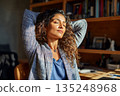 Serene Woman Relaxing at Home Office Desk Enjoying Peaceful Moment Sunlight 135248968