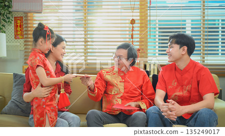 Asian grandparents giving red envelope to descendants during Chinese New Year family reunion Asian grandparents giving red envelope to descendants during Chinese New Year family reunion 135249017