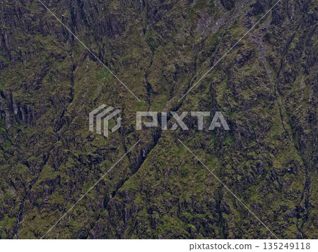 Dramatic slope of a mountain in the highlands, featuring small waterfalls trickling down the uneven face. 135249118