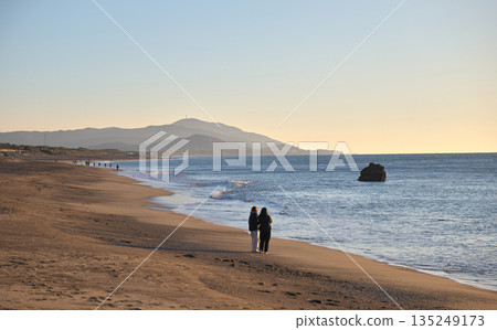 People walking on the sandy beach of Atsumi Peninsula at dusk People walking on the sandy beach of Atsumi Peninsula at dusk 135249173