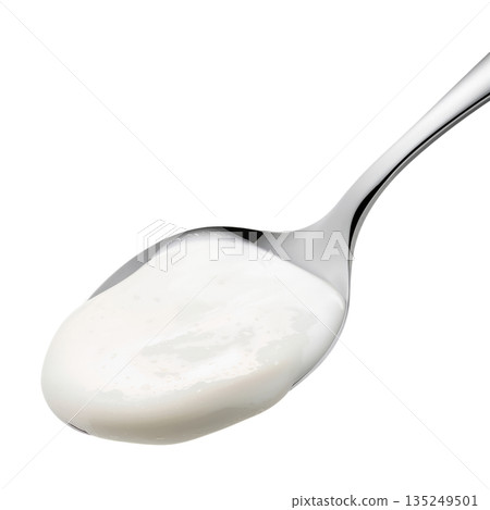 Cream is Placed on a Silver Spoon in a Bright Setting During a Kitchen Preparation Cream is Placed on a Silver Spoon in a Bright Setting During a Kitchen Preparation 135249501