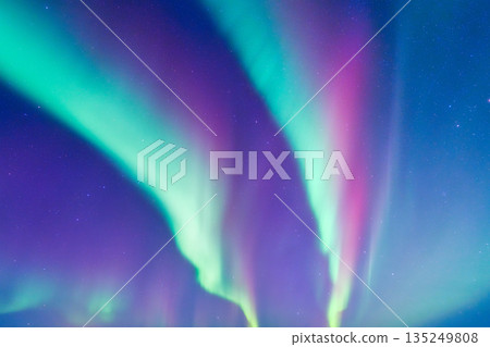 Spectacular Aurora Borealis dancing across the starry night sky.  135249808
