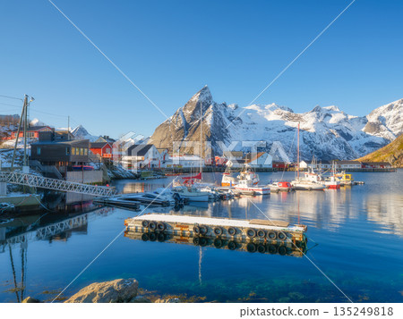 Lofoten Islands fishing village Reine with red rorbu cabins and boats Lofoten Islands fishing village Reine with red rorbu cabins and boats 135249818