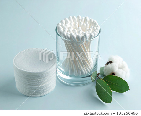 Remove makeup. White cotton swabs and reusable cotton pads neatly stacked on a white background. Remove makeup. White cotton swabs and reusable cotton pads neatly stacked on a white background. 135250460