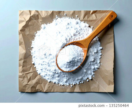 Nontoxic washing. Pile of powdered detergent with a wooden spoon on kraft paper on a white background. Nontoxic washing. Pile of powdered detergent with a wooden spoon on kraft paper on a white background. 135250464