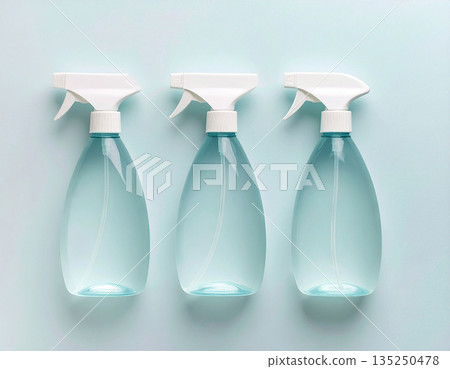 Home cleaning. Three transparent sprays in a row on a white background. Disinfectant, glass cleaner, all-purpose surface cleaner. Mockup for branding cleaning product. 135250478