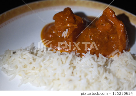Traditional Indian meals with colorful spices, rice, curry and flatbread served on decorated table. 135250634