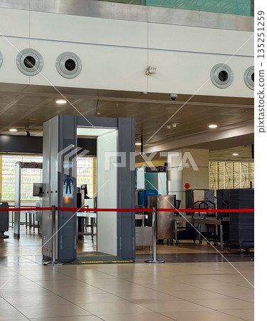 Airport security checkpoint with scanning machines and gates. Safety, regulation and travel control in modern transportation systems. Airport security checkpoint with scanning machines and gates. Safety, regulation and travel control in modern transportation systems. 135251259