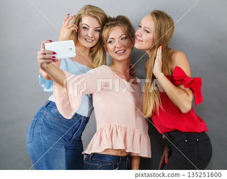 Fashionable women taking selfie 135251600